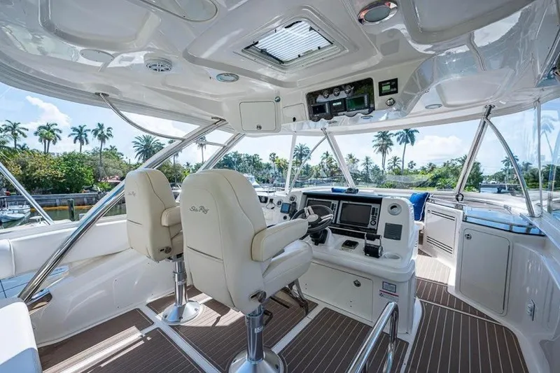 Slide: The Image of Luxurious 2013 Sea Ray 580 Sedan Bridge yacht interior with helm and plush seating. - 4