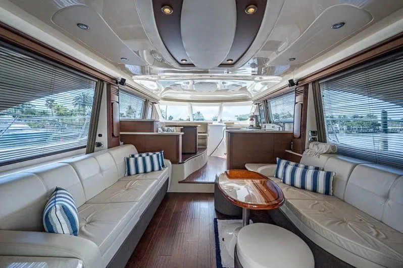 Slide: The Image of Luxurious interior of 2013 Sea Ray 580 Sedan Bridge yacht with elegant seating and panoramic windows. - 6