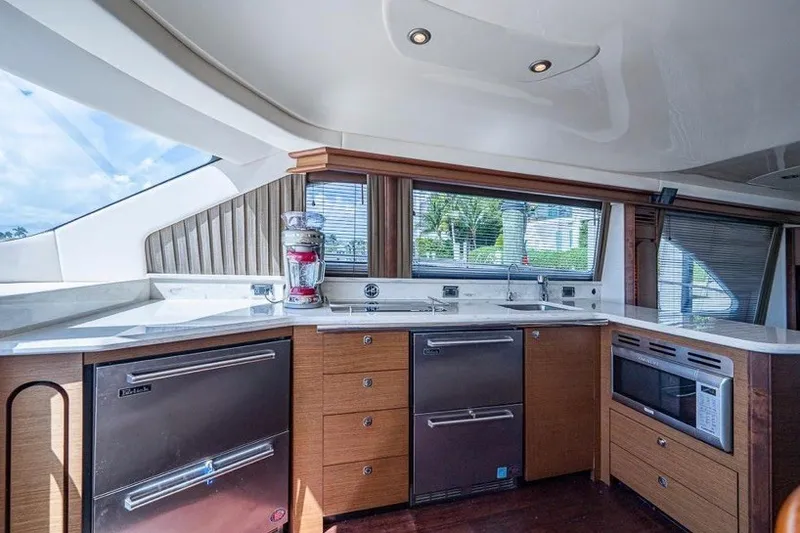 Slide: The Image of Luxurious kitchen interior of 2013 Sea Ray 580 Sedan Bridge yacht with modern appliances. - 7