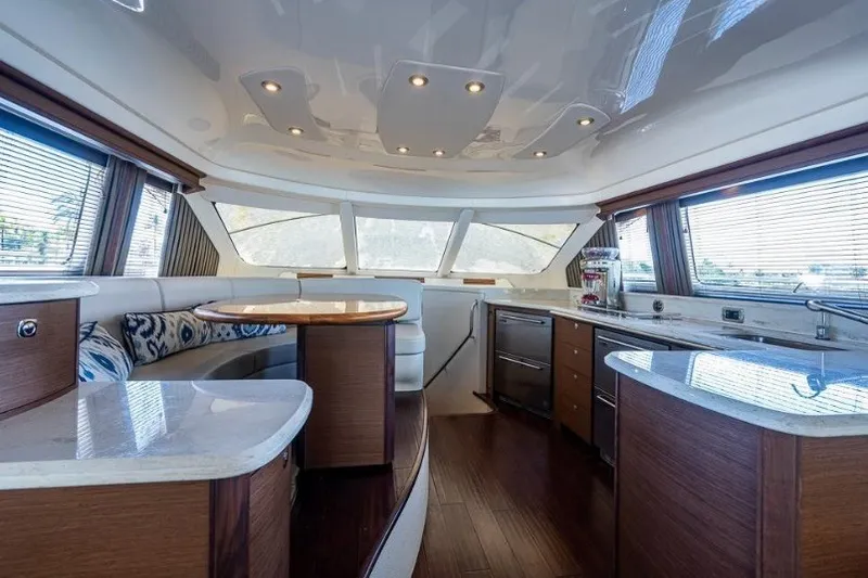Slide: The Image of Luxurious interior of 2013 Sea Ray 580 Sedan Bridge yacht with modern kitchen and seating area. - 9