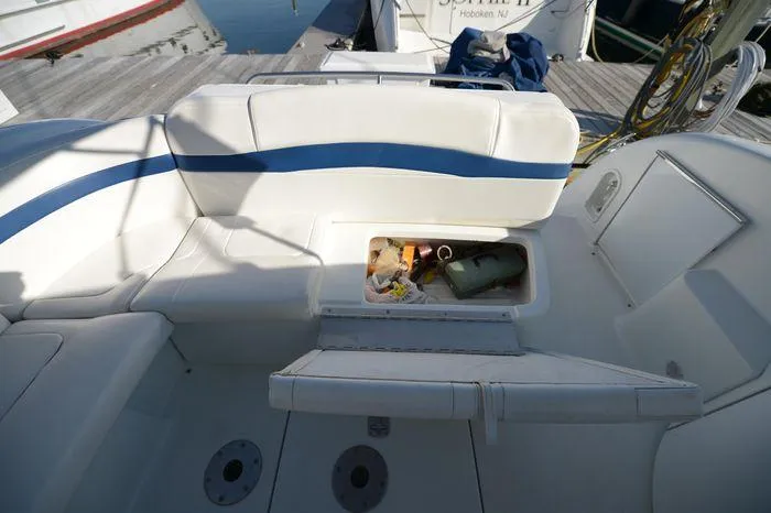 Slide: The Image of 2007 Formula 34 PC boat interior with open storage compartment on white seating. - 13
