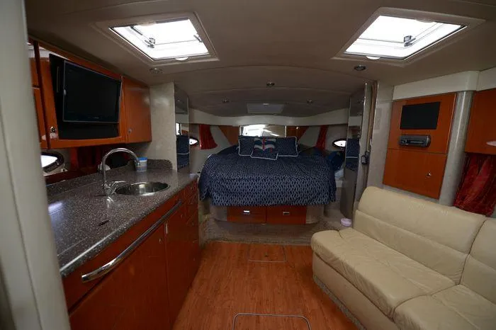 Slide: The Image of 2007 Formula 34 PC yacht interior with kitchen, bed, and seating area. - 22