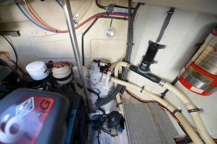 Slide: The Image of Engine compartment of a 2007 Formula 34 PC boat, showcasing mechanical components and wiring. - 32