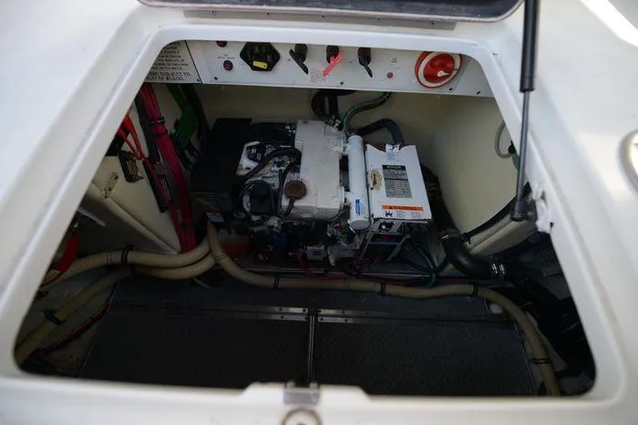 Slide: The Image of Engine compartment of a 2007 Formula 34 PC boat, showcasing mechanical components and wiring. - 36