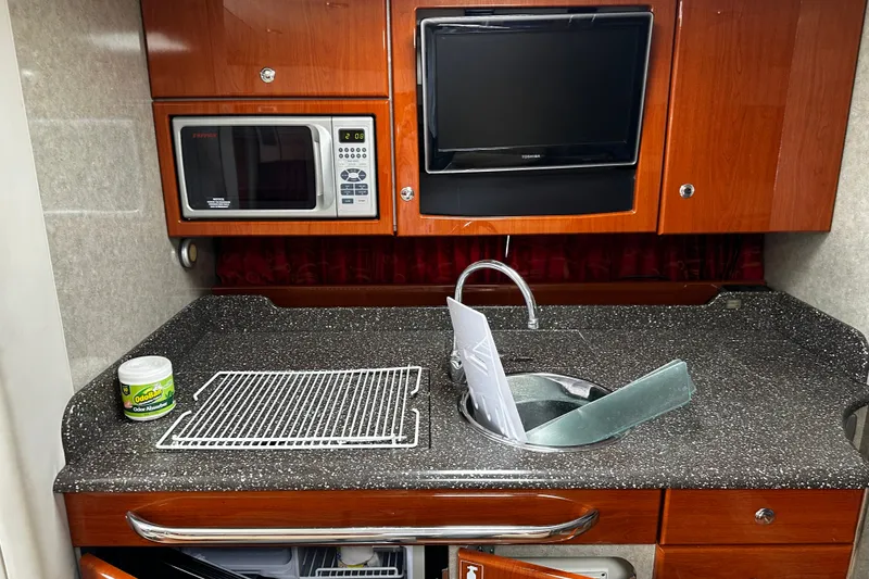 Slide: The Image of 2007 Formula 34 Performance Cruiser kitchen with microwave, TV, and sink. - 27