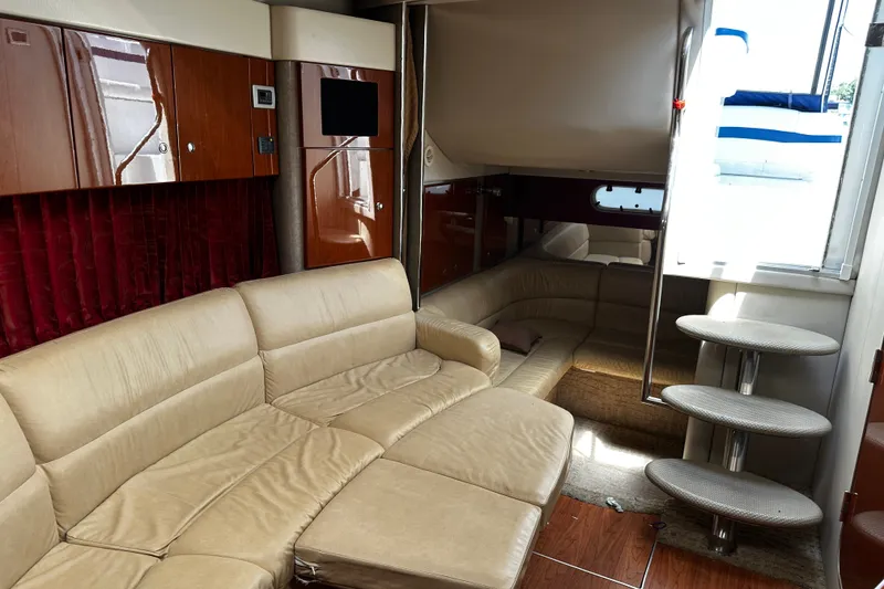 Slide: The Image of Luxurious interior of a 2007 Formula 34 Performance Cruiser with beige seating and wooden cabinetry. - 19