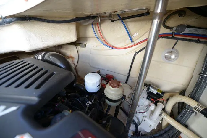 Slide: The Image of Engine compartment of a 2007 Formula 34 PC boat, showing various mechanical components and wiring. - 34