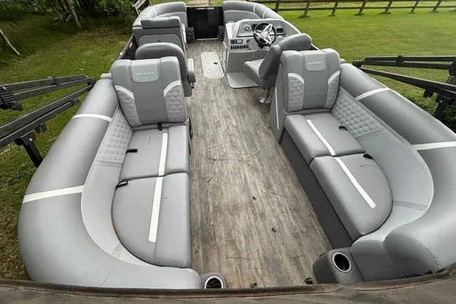 Slide: The Image of 2023 Crest Classic DLX 220 pontoon boat with spacious seating and modern design. - 14