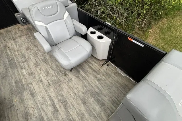 Slide: The Image of 2023 Crest Classic DLX 220 boat interior with gray seating and cup holders. - 11