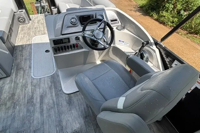 Slide: The Image of 2023 Crest Classic DLX 220 boat interior with steering wheel and control panel. - 23