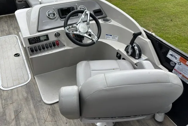 Slide: The Image of 2023 Crest Classic DLX 220 boat cockpit with steering wheel and control panel. - 9