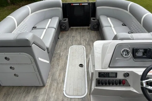 Slide: The Image of 2023 Crest Classic DLX 220 boat interior with gray seating and modern dashboard controls. - 8