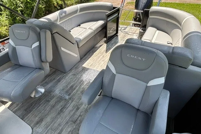 Slide: The Image of 2023 Crest Classic DLX 220 pontoon boat interior with gray seating and modern design. - 25