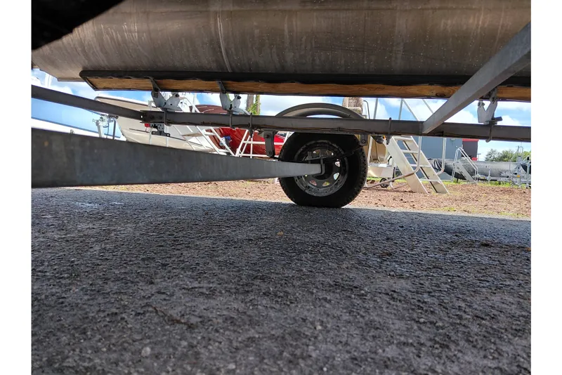 Slide: The Image of Underneath view of a 2023 Viaggio Del Mar C boat trailer on asphalt. - 38