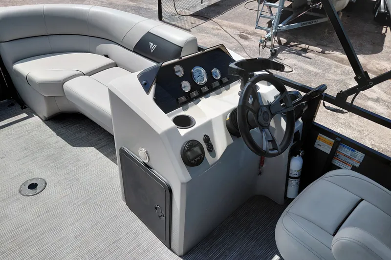 Slide: The Image of 2023 Viaggio Del Mar C boat interior with steering console and plush seating. - 22