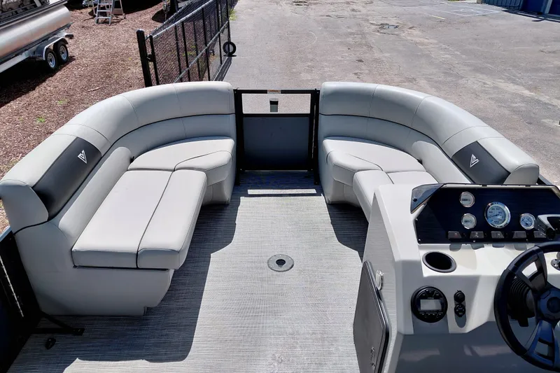 Slide: The Image of 2023 Viaggio Del Mar C pontoon boat interior with plush seating and modern dashboard. - 14