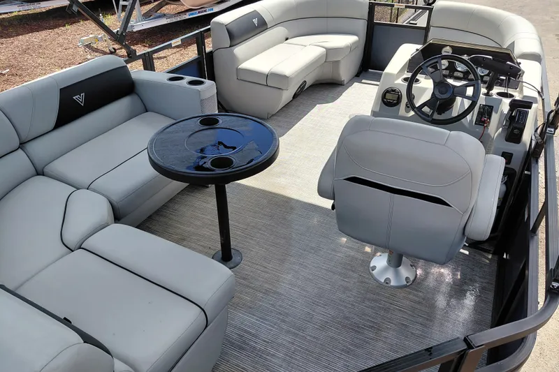 Slide: The Image of 2023 Viaggio Del Mar C pontoon boat interior with plush seating and steering console. - 32
