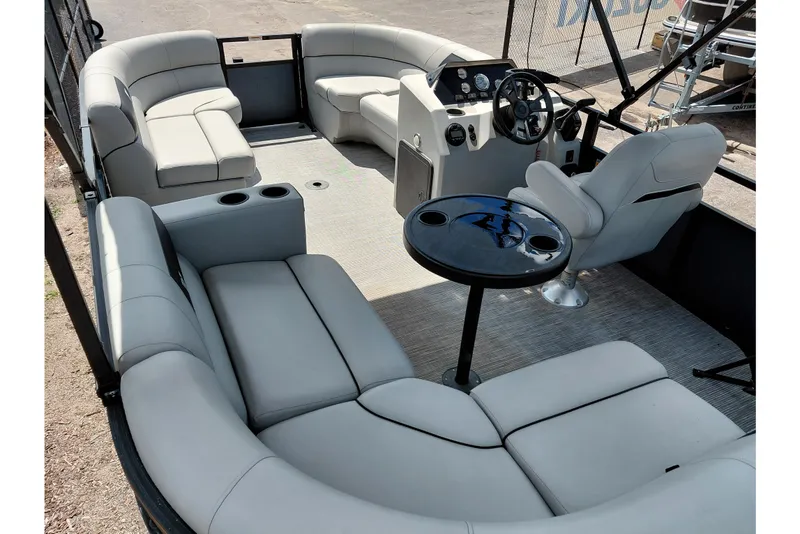 Slide: The Image of 2023 Viaggio Del Mar C pontoon boat interior with plush seating and steering console. - 35