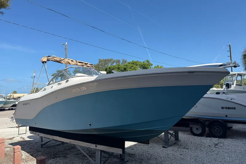 The Image of 2016 Sea Fox 226 Traveler boat on trailer, blue hull, parked outdoors under clear sky. - 0