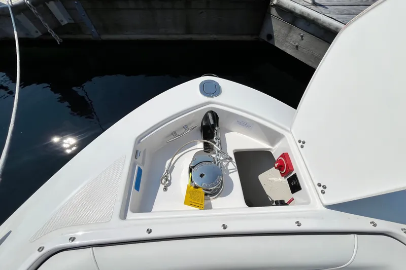 Slide: The Image of 2023 Regal LS6 boat anchor compartment with winch and control panel. - 3