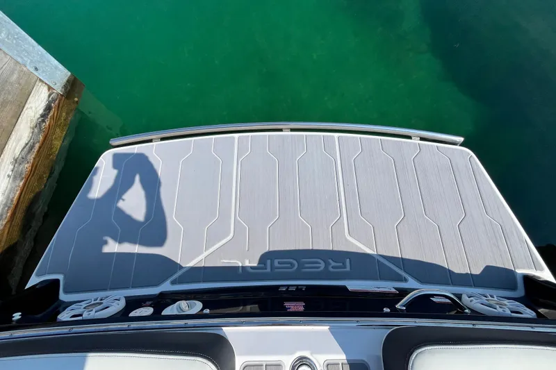 Slide: The Image of 2023 Regal LS6 boat swim platform with shadow over turquoise water. - 14