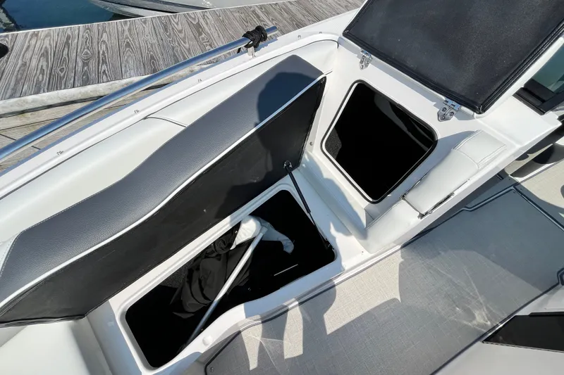 Slide: The Image of 2023 Regal LS6 boat interior storage compartments open at dockside. - 4