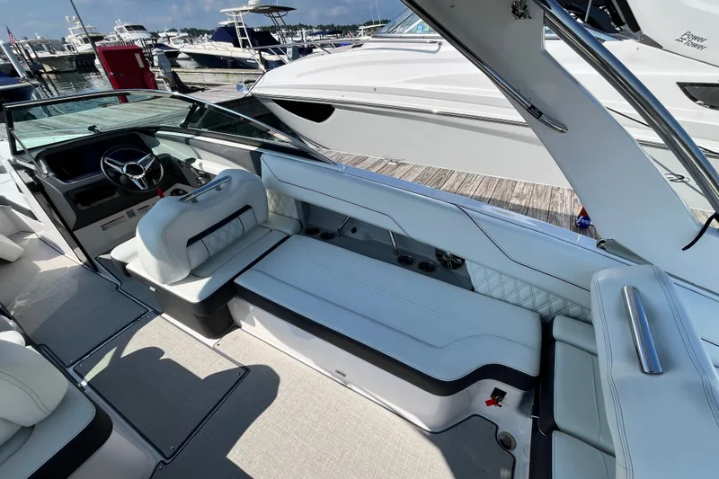 Slide: The Image of Luxurious interior of 2023 Regal LS6 boat, featuring sleek seating and modern design at a marina. - 10