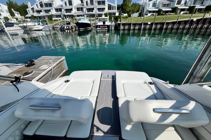 Slide: The Image of Luxury Regal LS6 boat docked at marina with modern waterfront homes, 2023 model. - 11