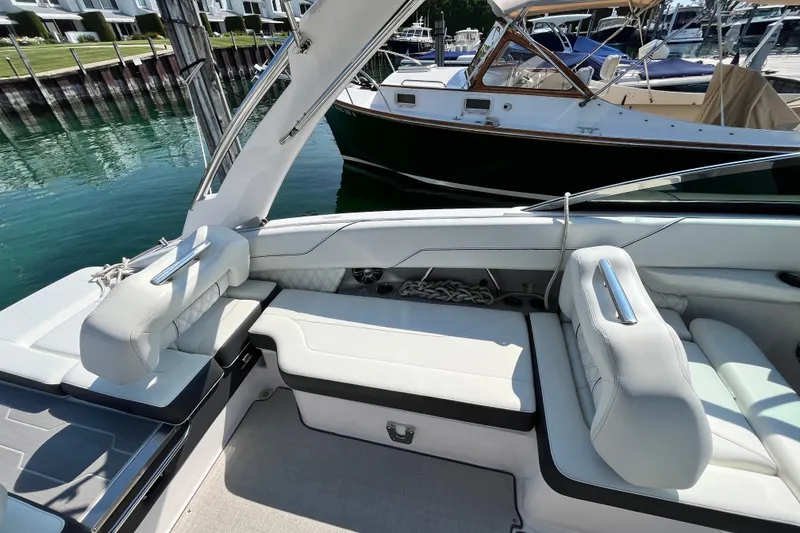 Slide: The Image of Luxurious 2023 Regal LS6 boat interior with white seating, docked at marina. - 9