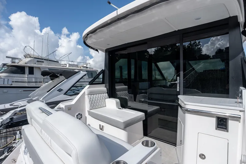 Slide: The Image of 2025 Regal 36 Grande Coupe yacht with sleek white interior and modern design. - 15