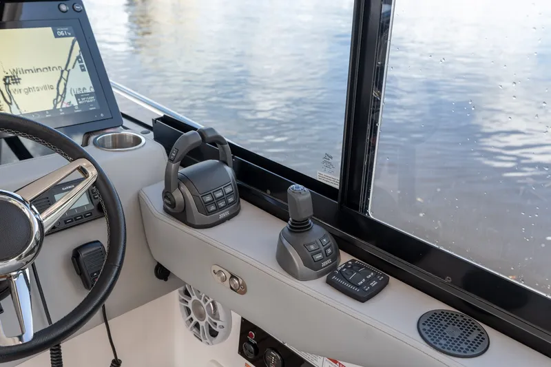 Slide: The Image of Helm of 2025 Regal 36 Grande Coupe with navigation controls and water view. - 34