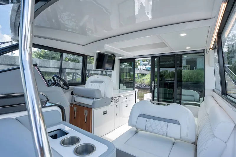Slide: The Image of Interior of 2025 Regal 36 Grande Coupe yacht with luxurious seating and modern amenities. - 17