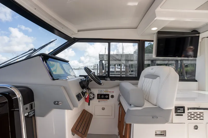 Slide: The Image of Interior of 2025 Regal 36 Grande Coupe, featuring modern helm and luxurious seating. - 35