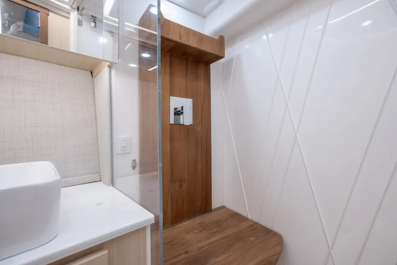 Slide: The Image of Modern bathroom interior of 2025 Regal 36 Grande Coupe yacht, featuring sleek design and wood accents. - 50