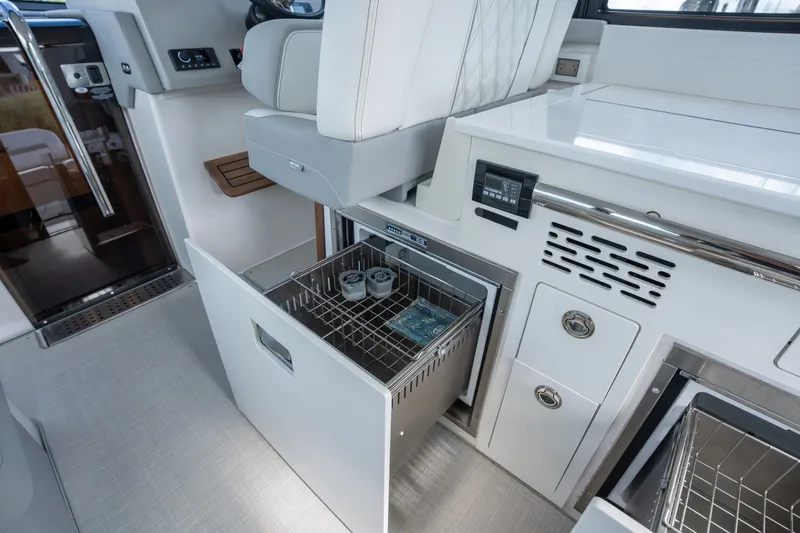 Slide: The Image of Interior of 2025 Regal 36 Grande Coupe featuring modern storage and seating. - 18