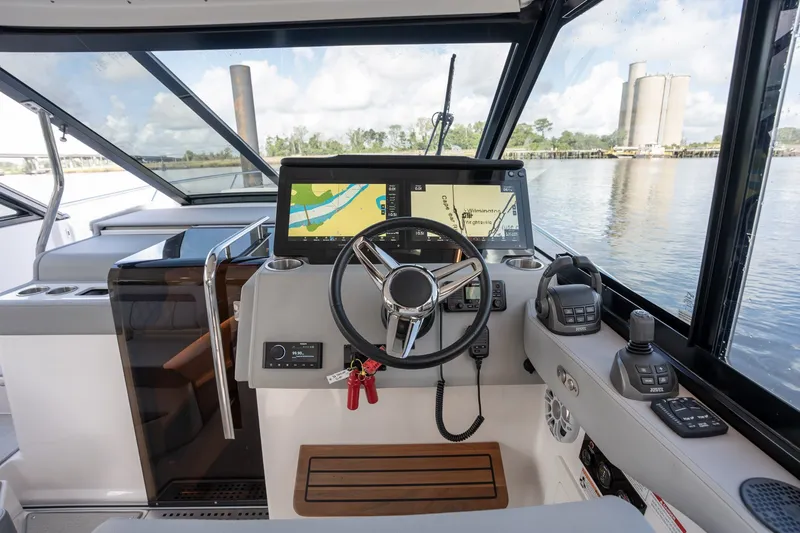 Slide: The Image of Helm of 2025 Regal 36 Grande Coupe with navigation display and controls. - 32