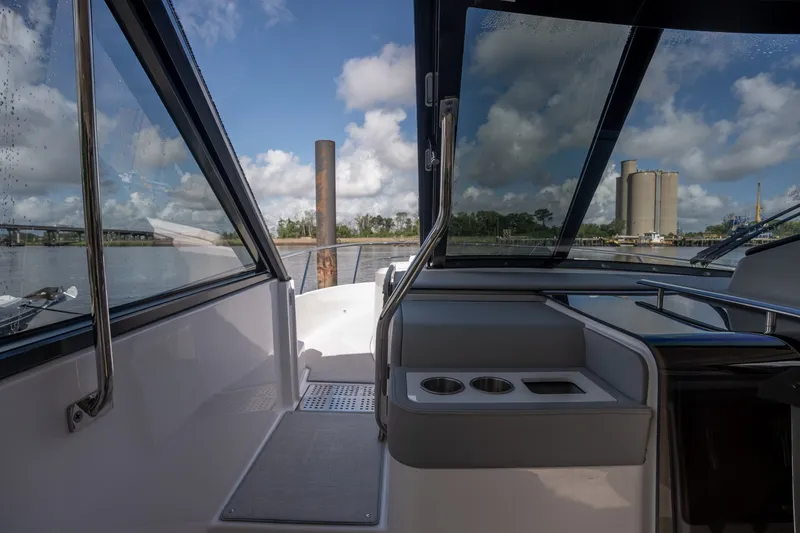 Slide: The Image of Interior view of 2025 Regal 36 Grande Coupe yacht with scenic waterway backdrop. - 37
