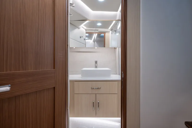 Slide: The Image of Modern bathroom interior of 2025 Regal 36 Grande Coupe yacht, featuring sleek wood finishes. - 48