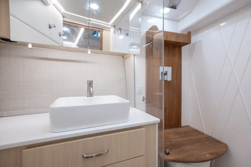 Slide: The Image of Modern bathroom interior of 2025 Regal 36 Grande Coupe yacht, featuring sleek sink and shower. - 49