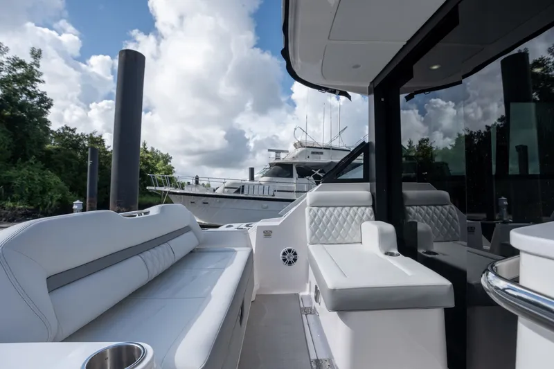 Slide: The Image of 2025 Regal 36 Grande Coupe luxury yacht interior with plush seating and modern design. - 16