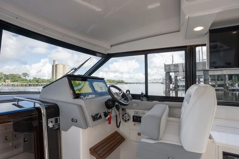 Slide: The Image of Interior view of 2025 Regal 36 Grande Coupe yacht cockpit with modern navigation system. - 28