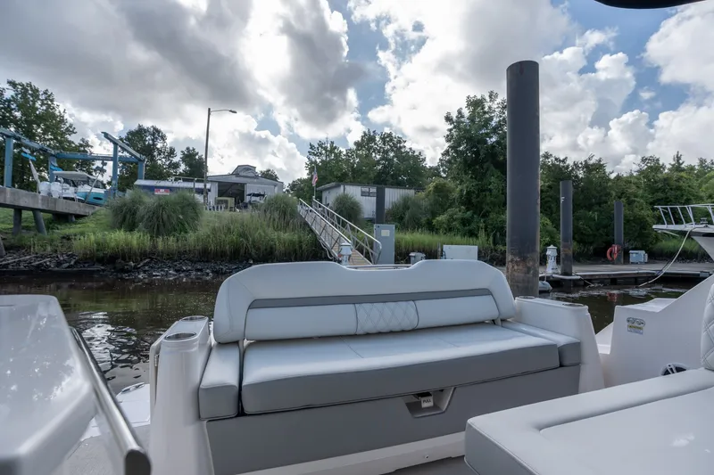 Slide: The Image of 2025 Regal 36 Grande Coupe docked, featuring luxurious seating and scenic marina backdrop. - 14