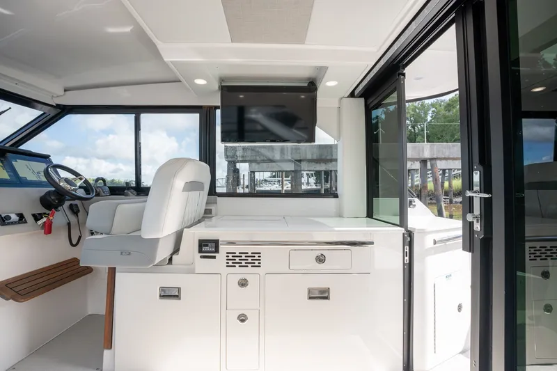 Slide: The Image of Interior of 2025 Regal 36 Grande Coupe, featuring helm station and modern design elements. - 23