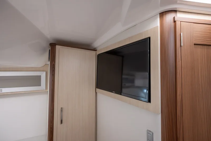 Slide: The Image of Interior of 2025 Regal 36 Grande Coupe featuring a mounted flat-screen TV. - 47