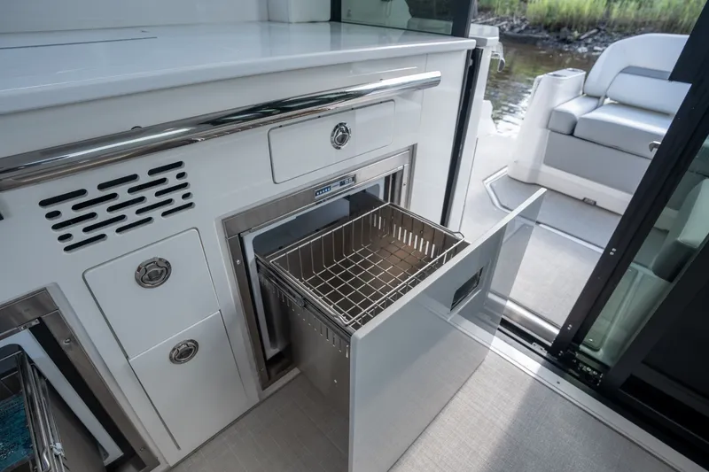 Slide: The Image of Luxury interior of 2025 Regal 36 Grande Coupe yacht with modern kitchen amenities. - 19