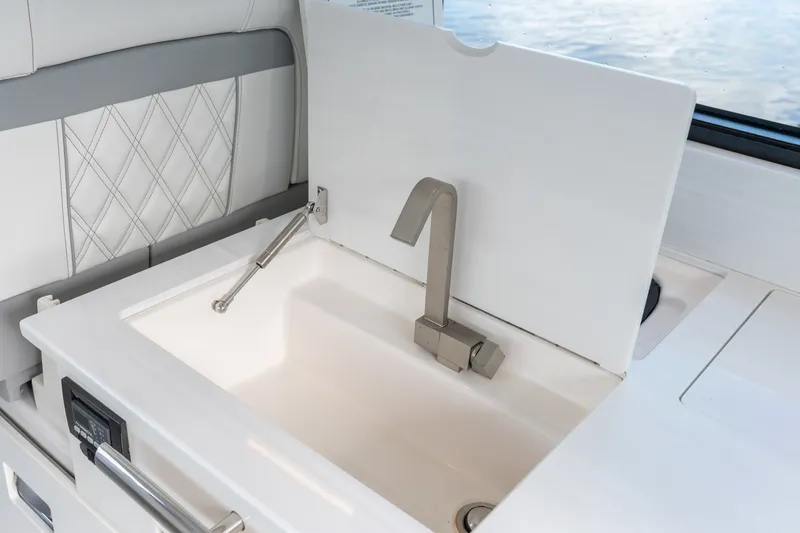 Slide: The Image of Luxury sink area on 2025 Regal 36 Grande Coupe yacht, featuring modern design and elegant fixtures. - 25
