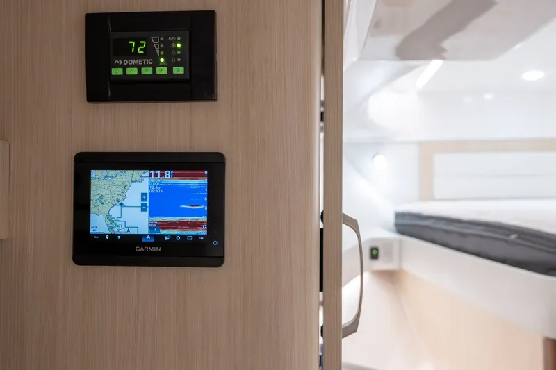 Slide: The Image of Control panels inside 2025 Regal 36 Grande Coupe, featuring Garmin navigation and Dometic climate systems. - 55