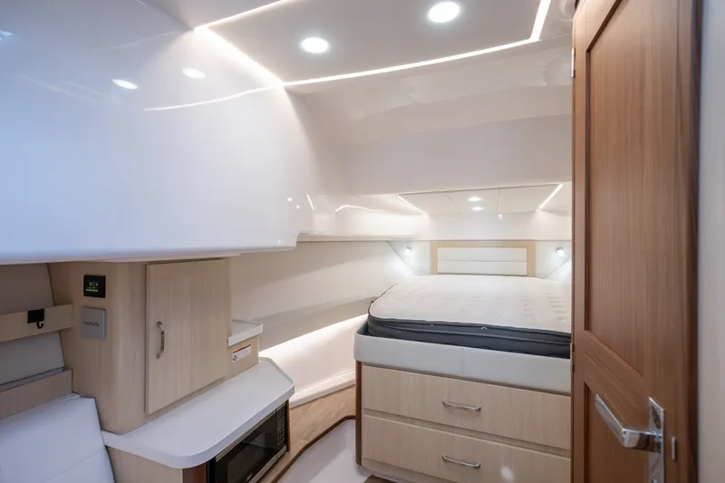 Slide: The Image of Luxurious interior of 2025 Regal 36 Grande Coupe yacht with modern amenities and cozy sleeping area. - 41