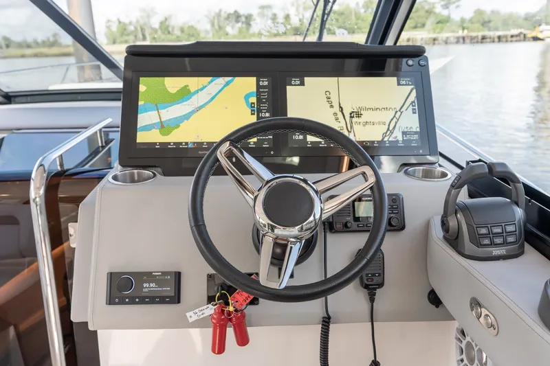Slide: The Image of Helm of 2025 Regal 36 Grande Coupe with advanced navigation displays and controls. - 33