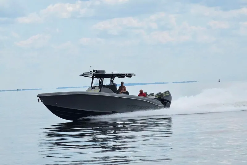 The Image of 2023 Statement 380 Open boat speeding on calm water under a cloudy sky. - 10